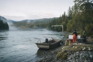 Canadian river fisheries monitoring scene with a workboat, field staff and conservation equipment