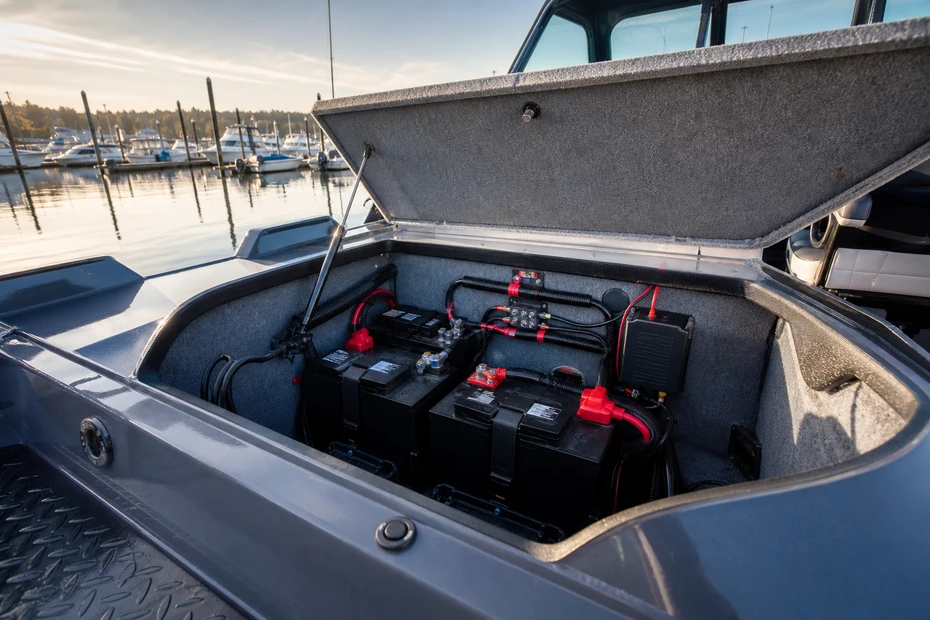 Secured marine battery bank and onboard charger inside a Canadian fishing boat