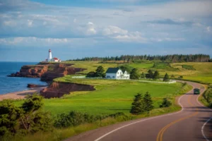 Prince Edward Island red cliffs lighthouse green fields farmhouse and scenic coastal road