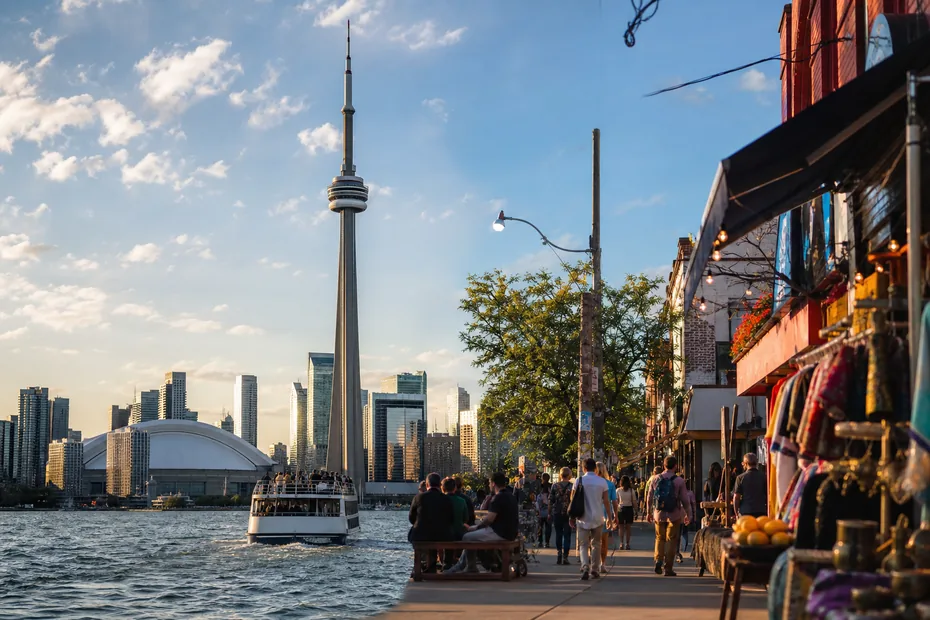 Toronto skyline and CN Tower beside the harbour and a lively market street