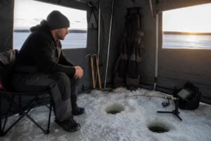 Canadian angler applying deadsticking for winter walleye in realistic northern water conditions