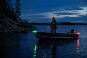 Canadian angler applying night fishing for walleye in realistic northern water conditions